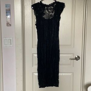 Black lace dress with ruffle sleeves.